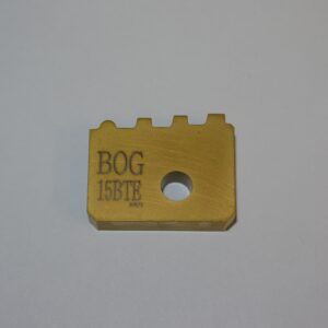 A gold colored block with the word " bog 1 5 8 tr ".