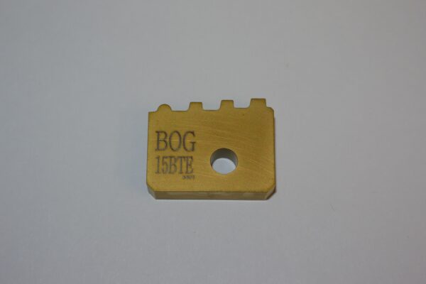 A gold colored block with the word " bog 1 5 8 tr ".