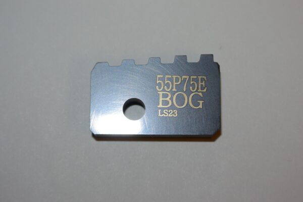 A metal piece of equipment with the words " 5 5 p 7 5 e bog 1 8 2 3 ".