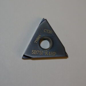 A triangle shaped cutter with a hole in it.