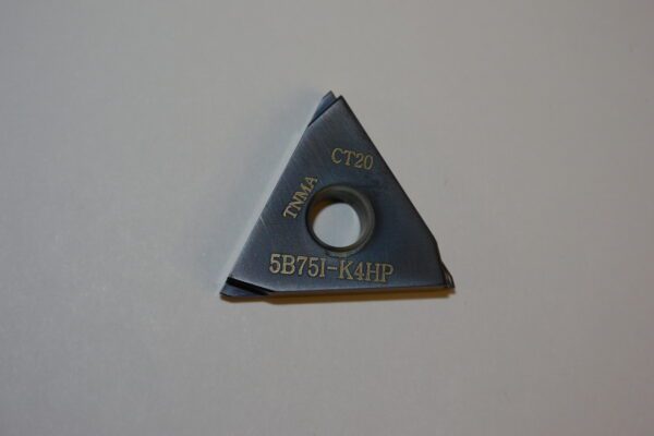 A triangle shaped cutter with a hole in it.