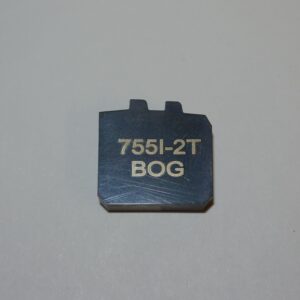 A small piece of metal with the words " 7 5 5 1-2 t " written on it.