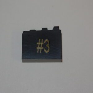 A lego brick with the number three on it.