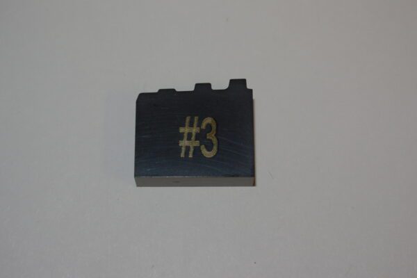 A lego brick with the number three on it.