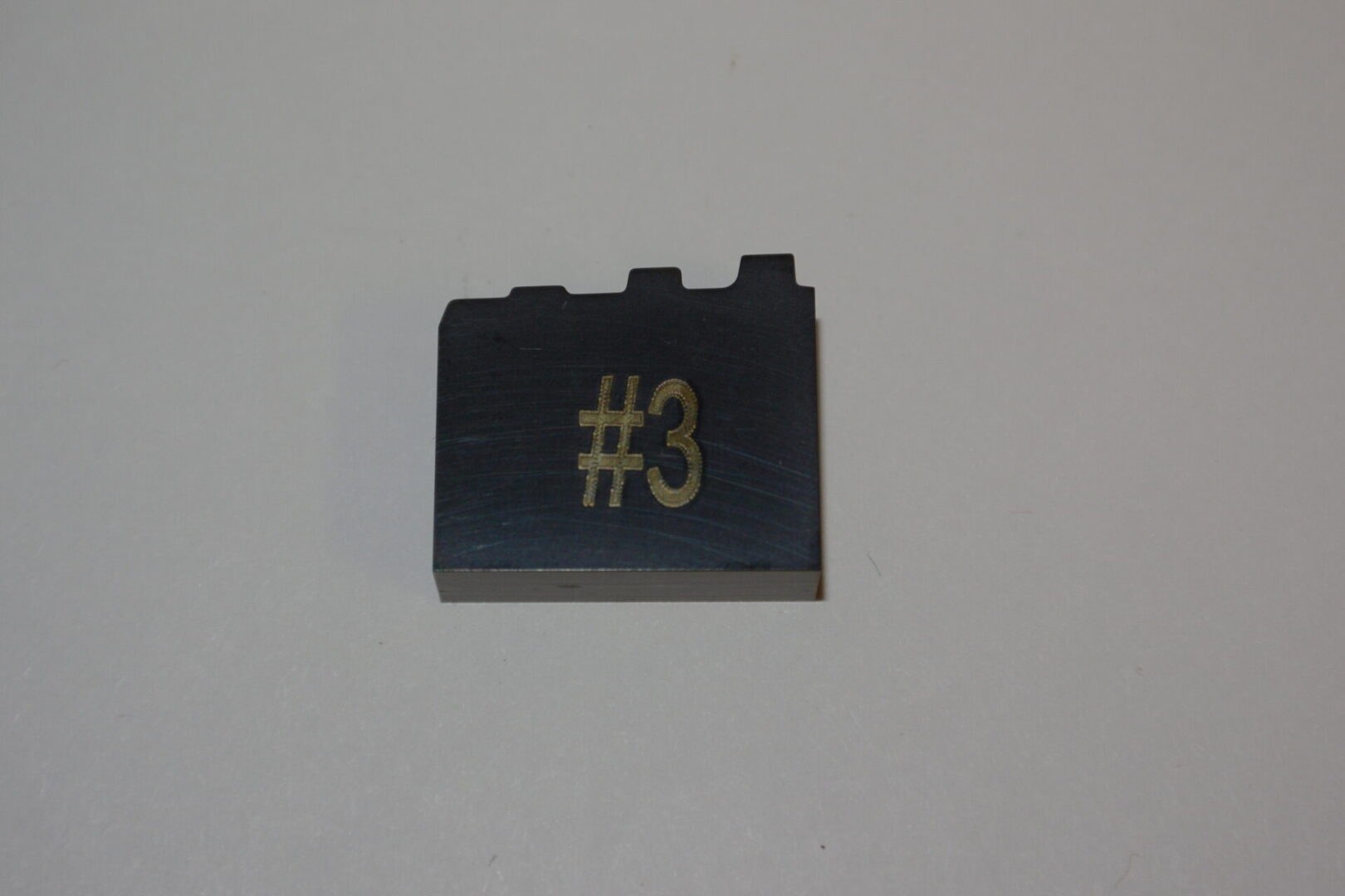 A lego brick with the number three on it.