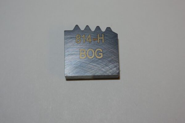 A metal block with the words " 8 4 h bog " written on it.